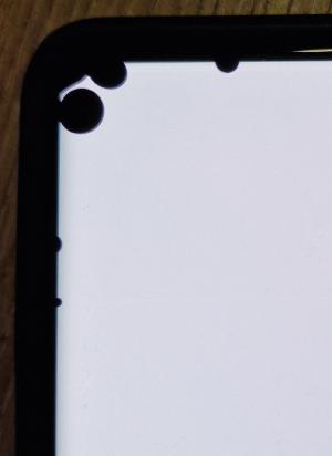White phone screen with black dots in the top left corner