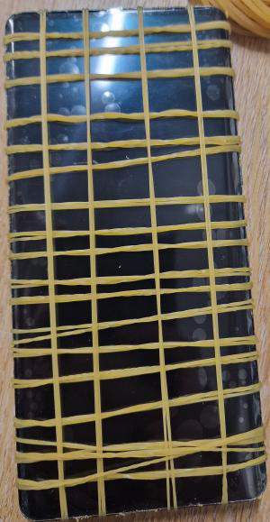 A phone wrapped in a grid of elastic bands